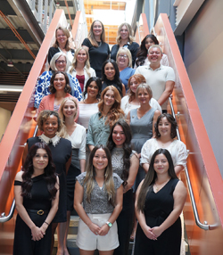 Nursing graduates standing on stairwell